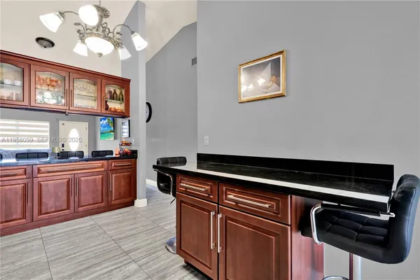 a kitchen with stainless steel appliances granite countertop a stove and a microwave