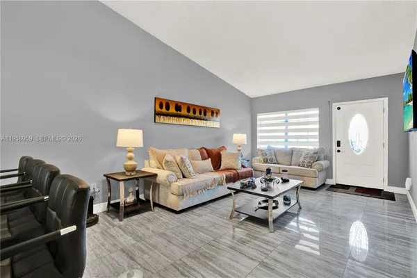 a living room with furniture a rug and a window