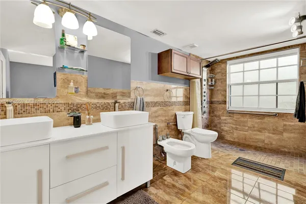 a bathroom with a sink toilet a mirror and vanity
