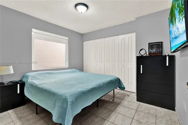 a bedroom with a bed and a tv