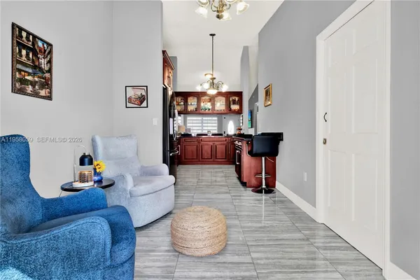 a living room with furniture and a chandelier