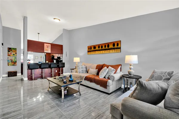 a living room with furniture and a lamp