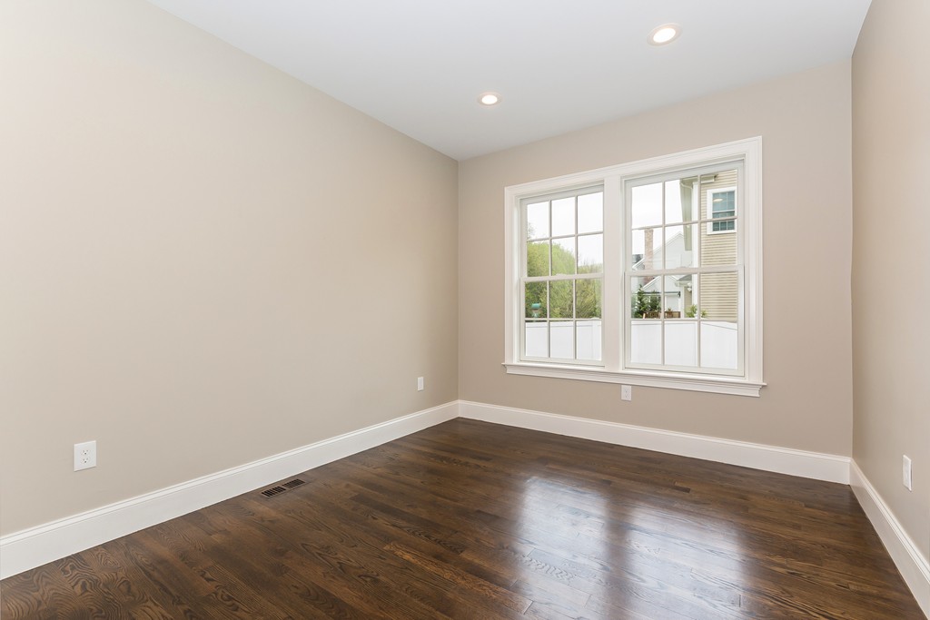 14 Jackson Road Wellesley, MA 02481 - Photo 11 of 28 an empty room with wooden floor and windows