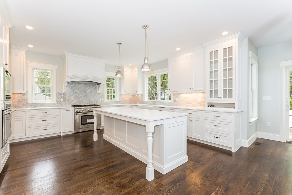 14 Jackson Road Wellesley, MA 02481 - Photo 7 of 28 a kitchen with white cabinets and stainless steel appliances