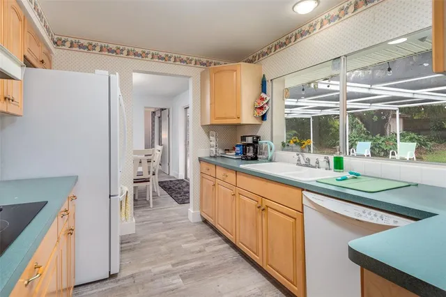 a view of a dining room with furniture large windows and wooden floor