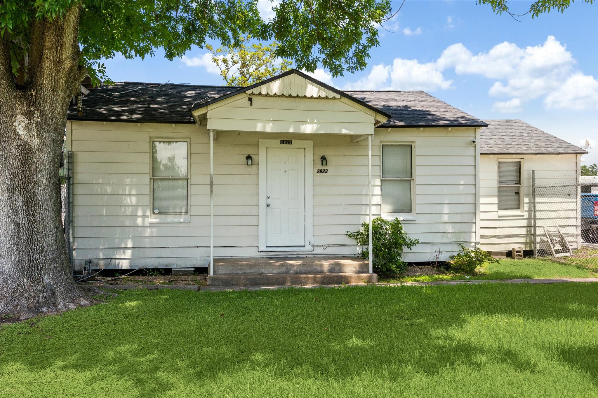 a front view of a house with a garden