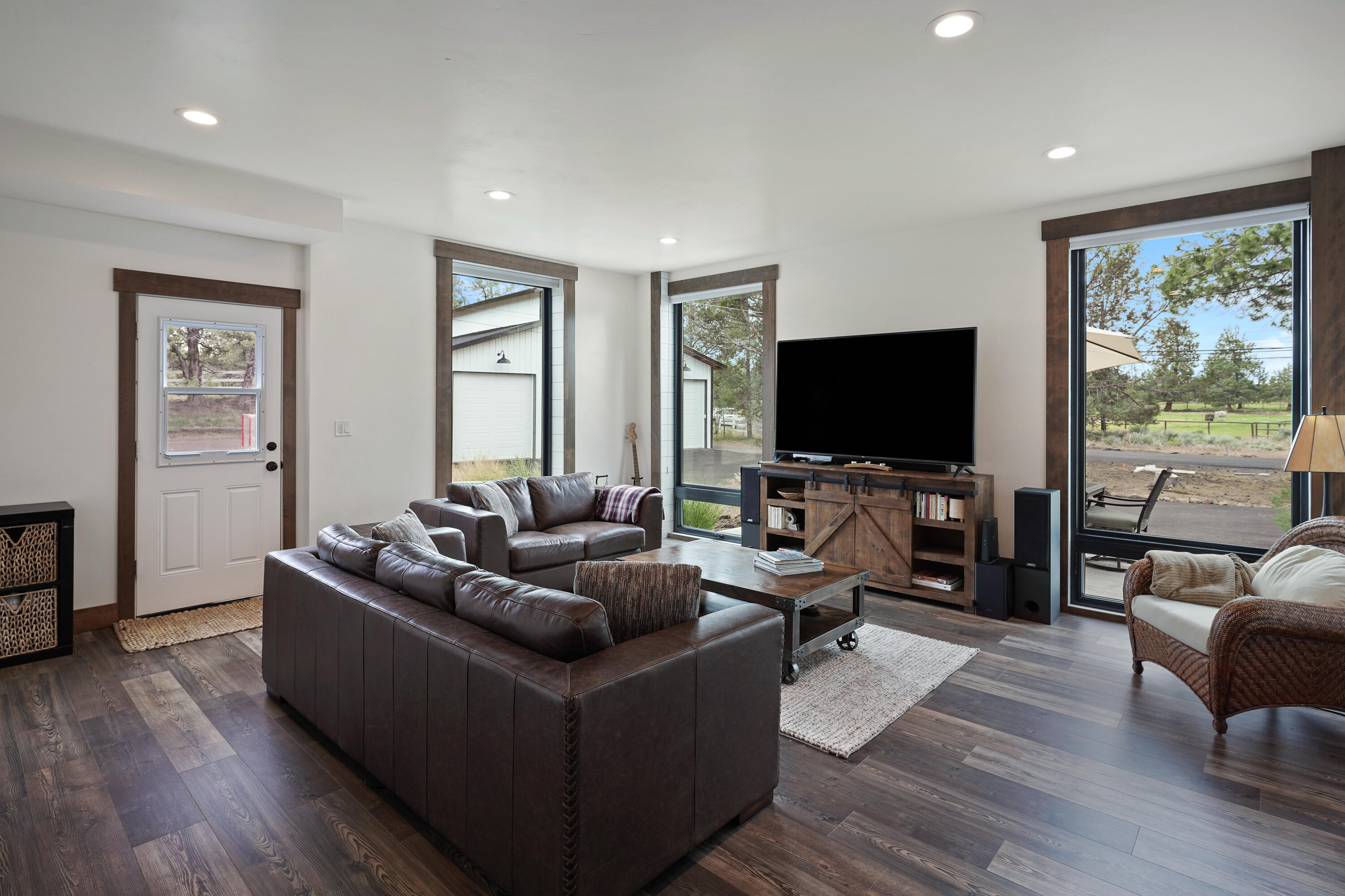 64732 Hunnell Road Bend, OR 97703 - Photo 25 of 51 a living room with furniture and a flat screen tv
