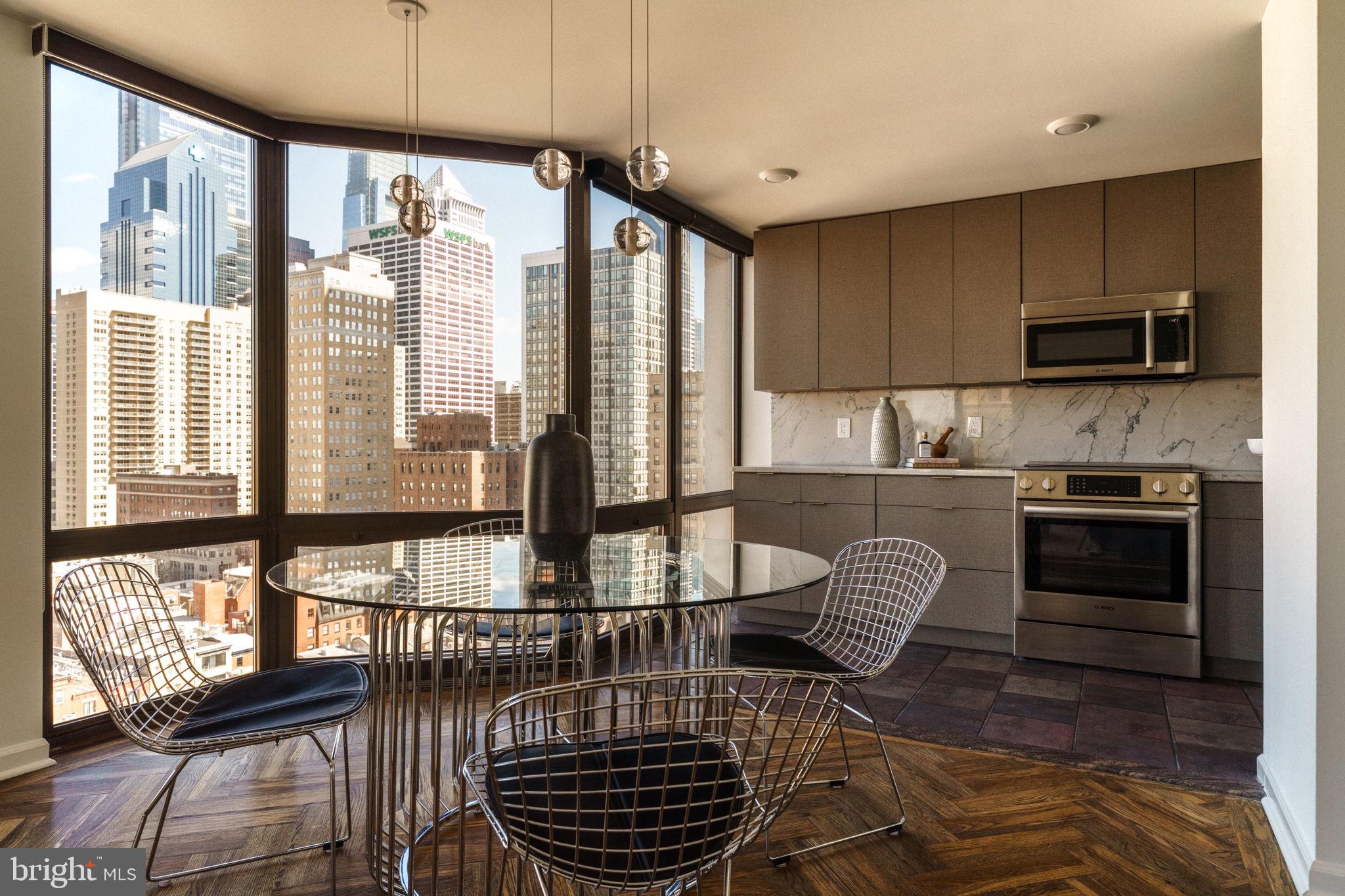 a kitchen with stainless steel appliances kitchen island granite countertop a stove a sink and a microwave