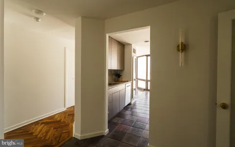 a kitchen with stainless steel appliances wooden cabinets and a large window