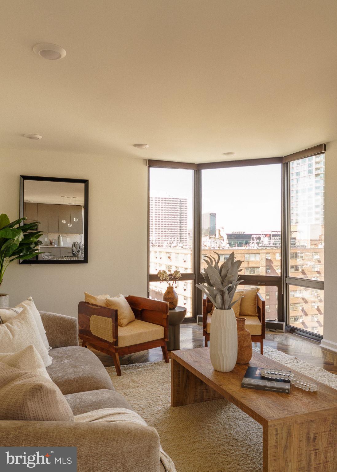2018-32 Walnut Street, Unit 16GH Philadelphia, PA 19103 - Photo 26 of 78 a living room with furniture and a large window