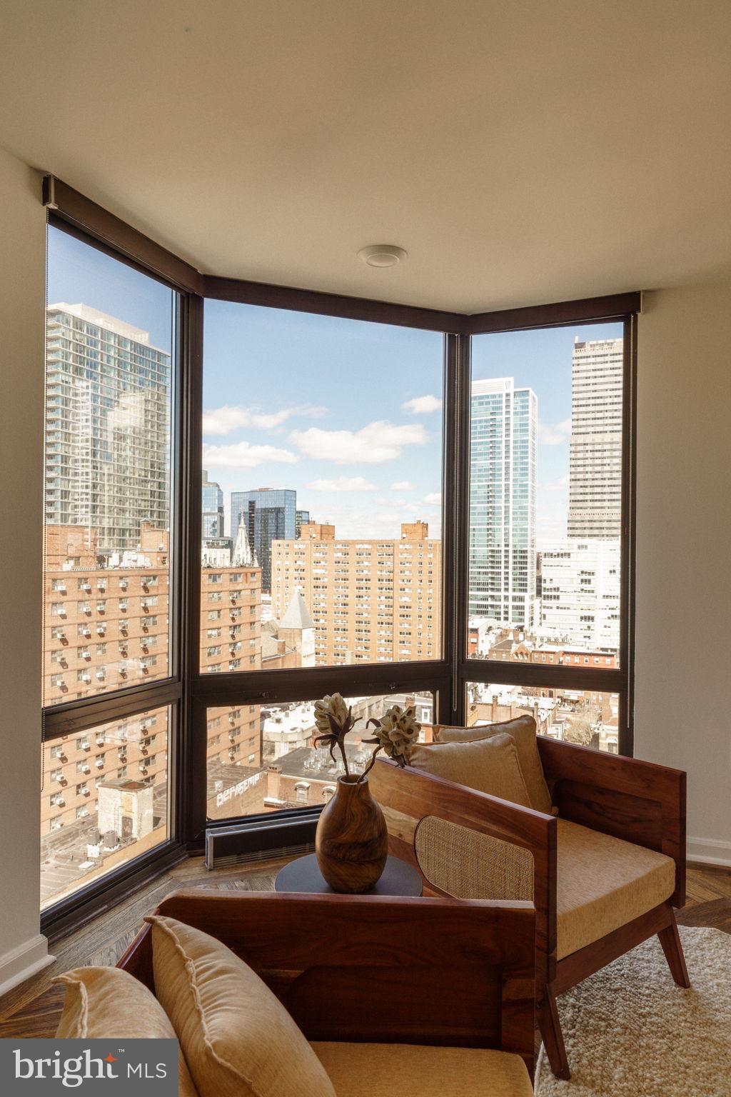2018-32 Walnut Street, Unit 16GH Philadelphia, PA 19103 - Photo 27 of 78 a living room with furniture and a floor to ceiling window
