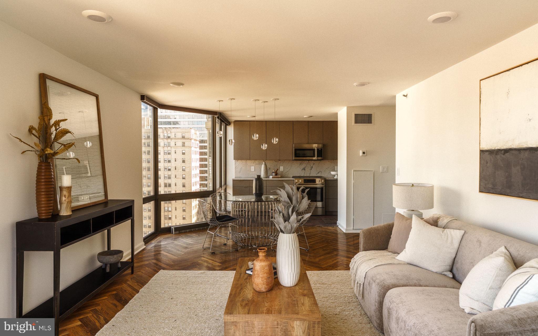 2018-32 Walnut Street, Unit 16GH Philadelphia, PA 19103 - Photo 29 of 78 a living room with furniture a flat screen tv and a large window