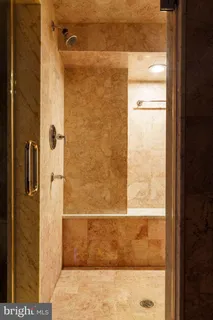 a bathroom with a granite countertop sink a toilet and mirror