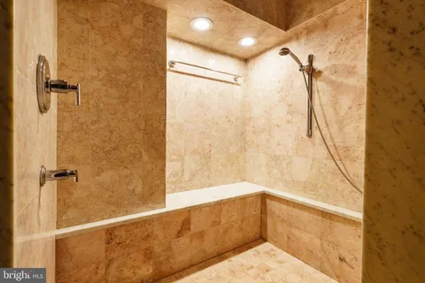 a bathroom with a shower and a glass door