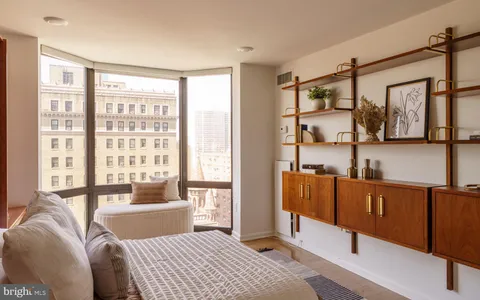 a bed room with a bed and a television