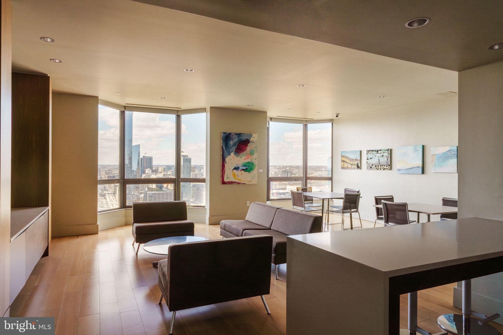 2018-32 Walnut Street, Unit 16GH Philadelphia, PA 19103 - Photo 63 of 78 a living room with furniture large windows and wooden floor