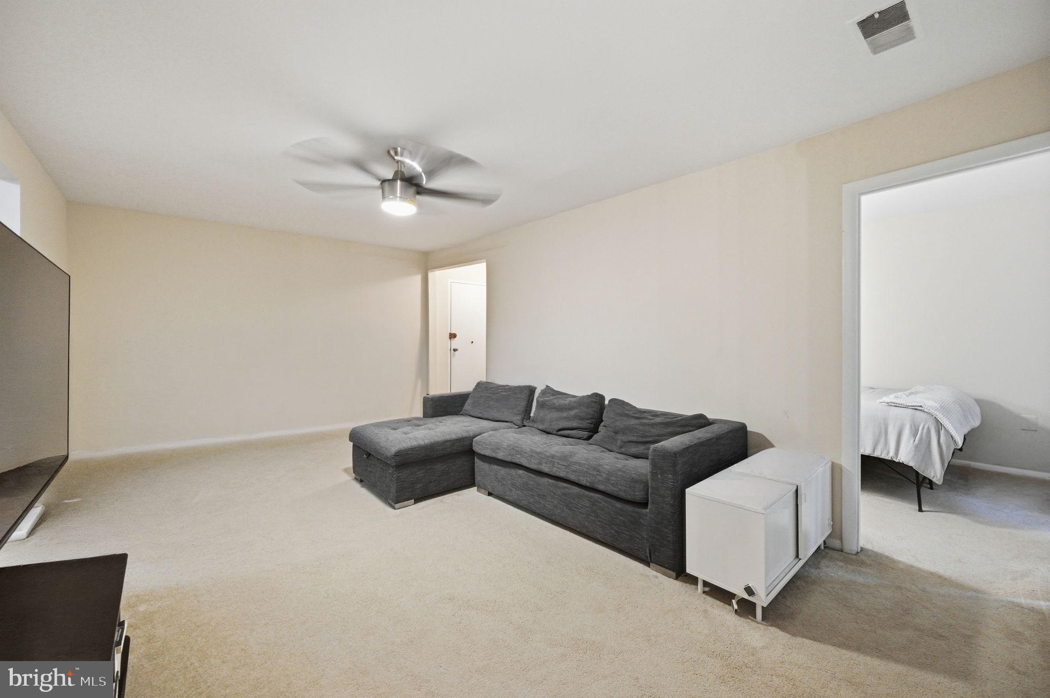 3366 Woodburn Road, Unit 23 Annandale, VA 22003 - Photo 7 of 16 a living room with furniture and a ceiling fan