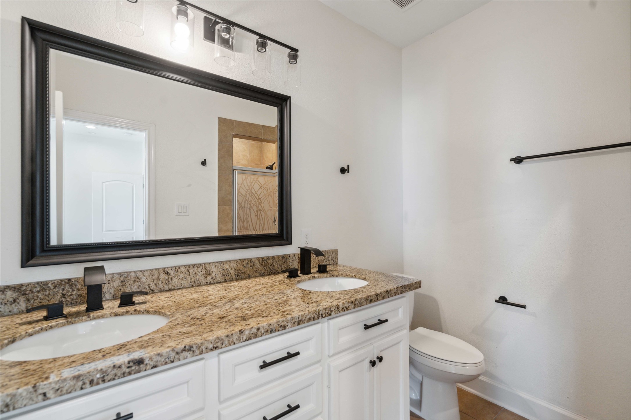 5402 Jonathan Lane Houston, TX 77011 - Photo 12 of 19 a bathroom with a granite countertop sink and a mirror