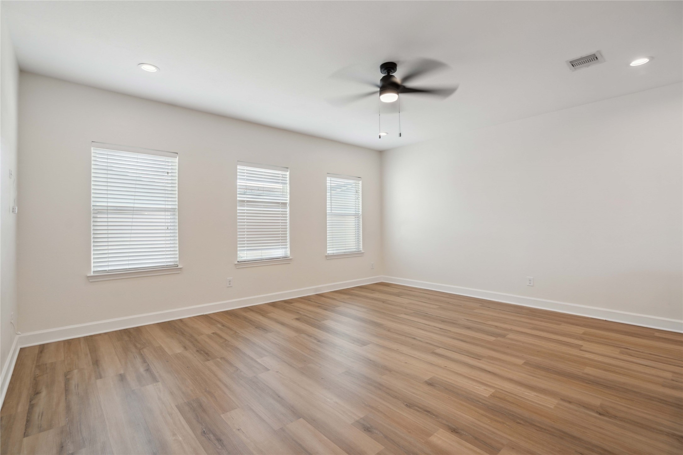 5402 Jonathan Lane Houston, TX 77011 - Photo 4 of 19 wooden floor in an empty room with a window