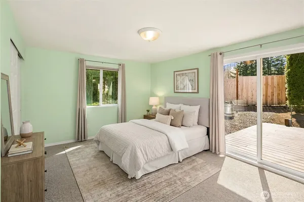 a bedroom with a large bed and a tv