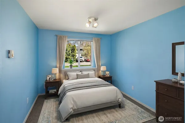 a bedroom with a bed and a flat tv screen on dresser