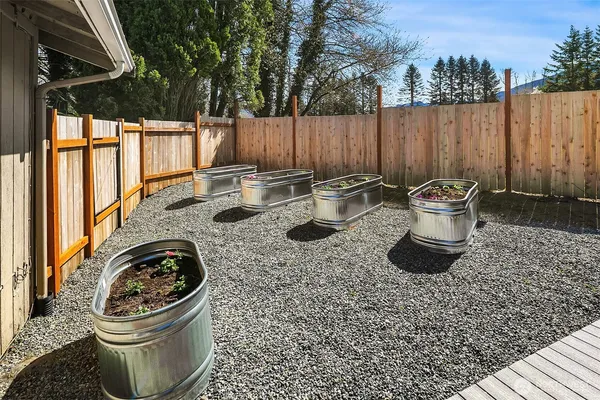 a view of a backyard with table and chairs and a fire pit