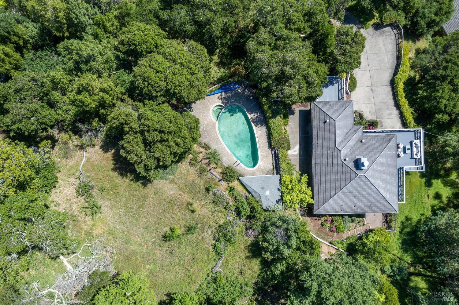 an aerial view of a house with a yard basket ball court and outdoor seating