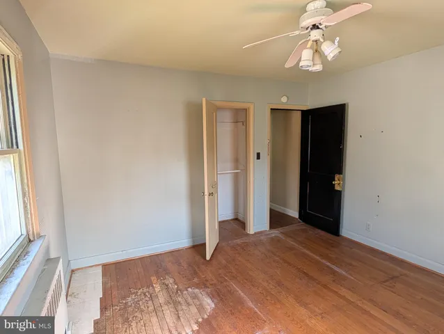 a view of a room with a chandelier fan and a window