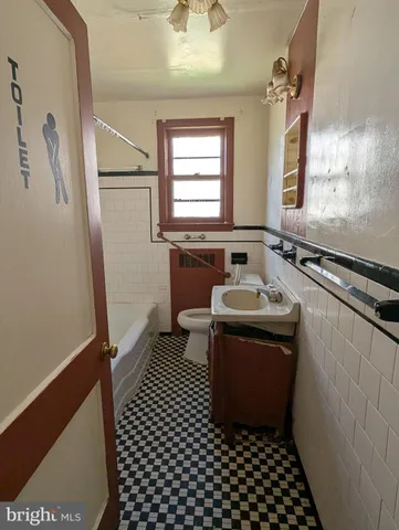 a bathroom with a sink a mirror and a bathtub