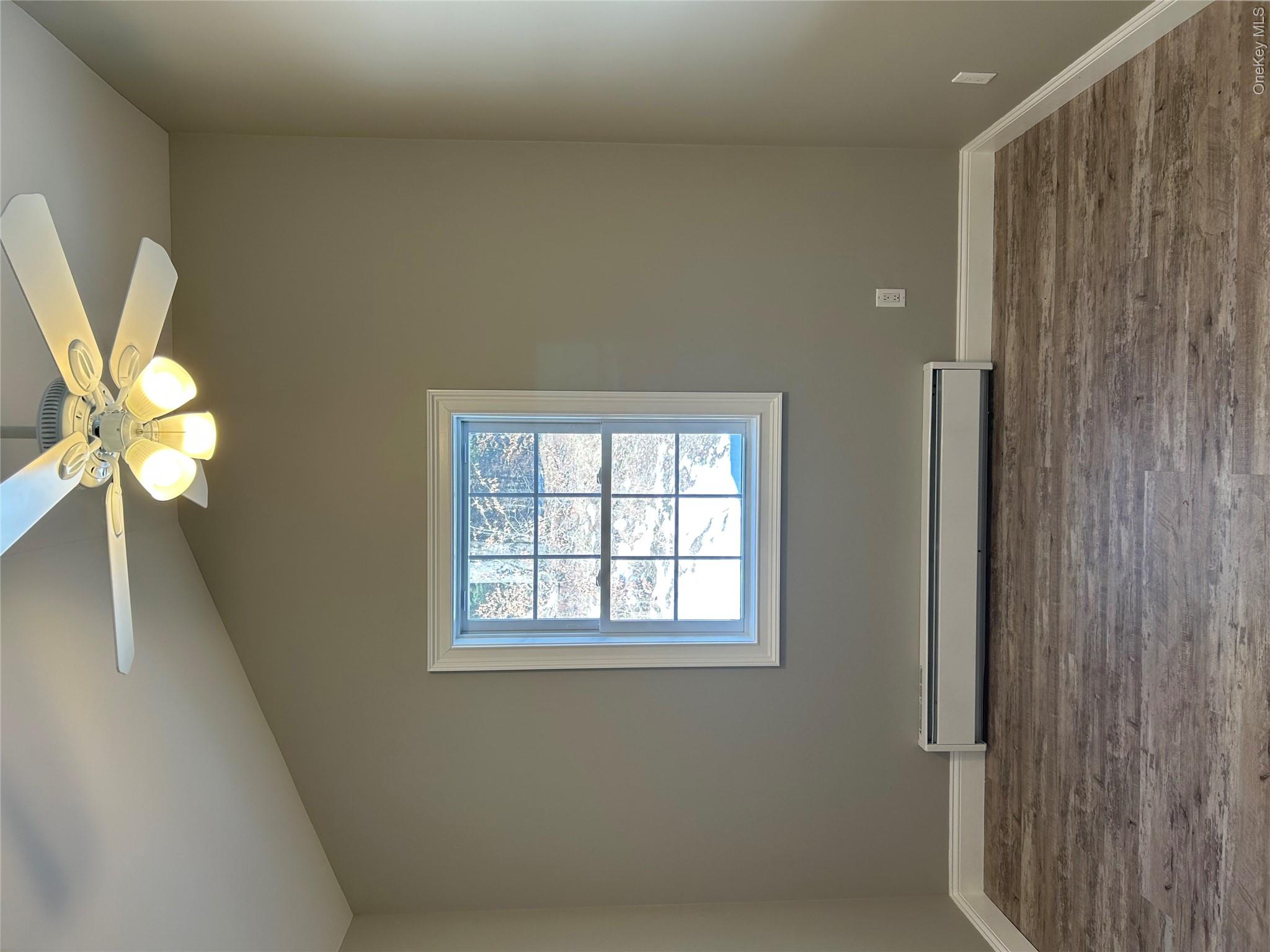 135 Gale Road, Unit UPSTAIRS Mongaup Valley, NY 12762 - Photo 12 of 23 a view of an empty room with wooden floor and a window