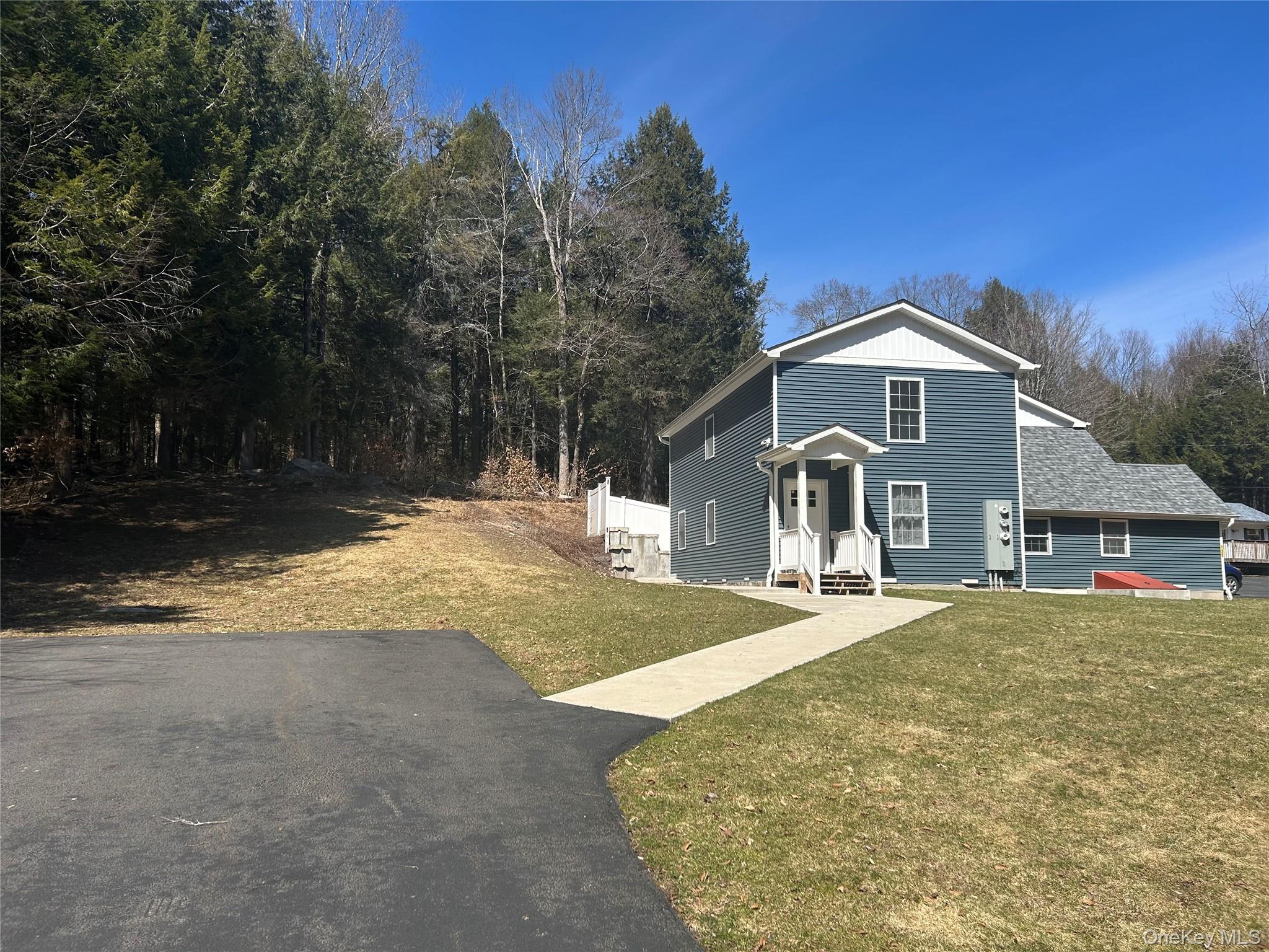 135 Gale Road, Unit UPSTAIRS Mongaup Valley, NY 12762 - Photo 3 of 23 a front view of a house with a yard and garage