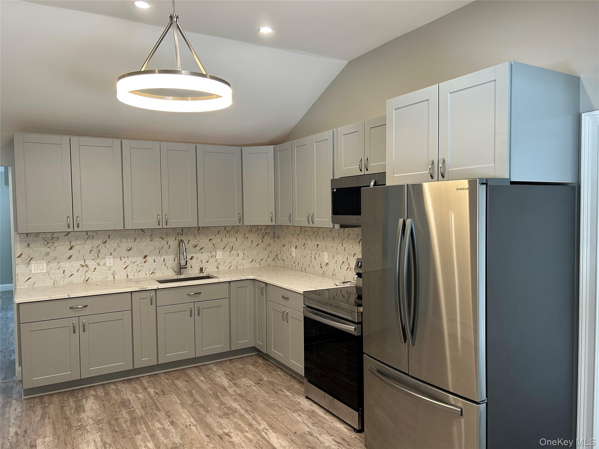 135 Gale Road, Unit UPSTAIRS Mongaup Valley, NY 12762 - Photo 6 of 23 a kitchen with stainless steel appliances granite countertop a refrigerator sink and stove