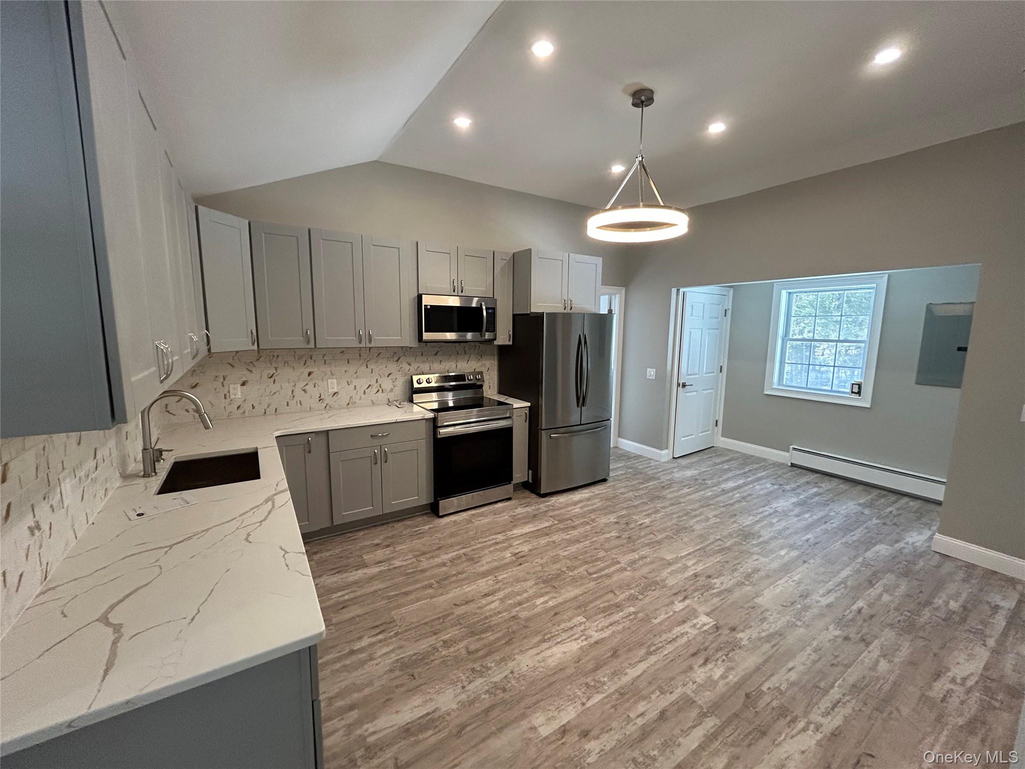 135 Gale Road, Unit UPSTAIRS Mongaup Valley, NY 12762 - Photo 7 of 23 a kitchen with stainless steel appliances granite countertop a sink refrigerator stove and microwave