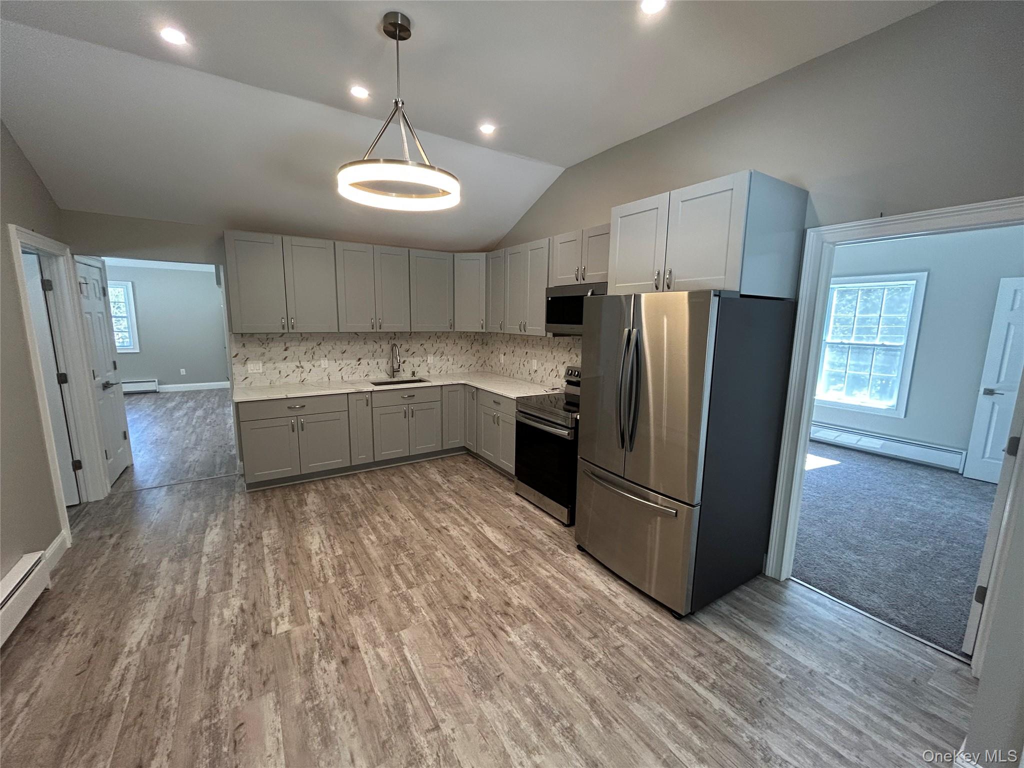 135 Gale Road, Unit UPSTAIRS Mongaup Valley, NY 12762 - Photo 8 of 23 a large kitchen with stainless steel appliances granite countertop a refrigerator and a stove top oven