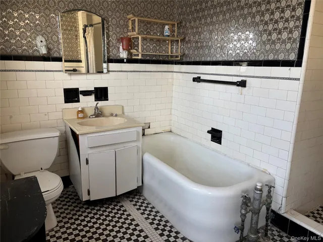 a bathroom with a sink a toilet and mirror