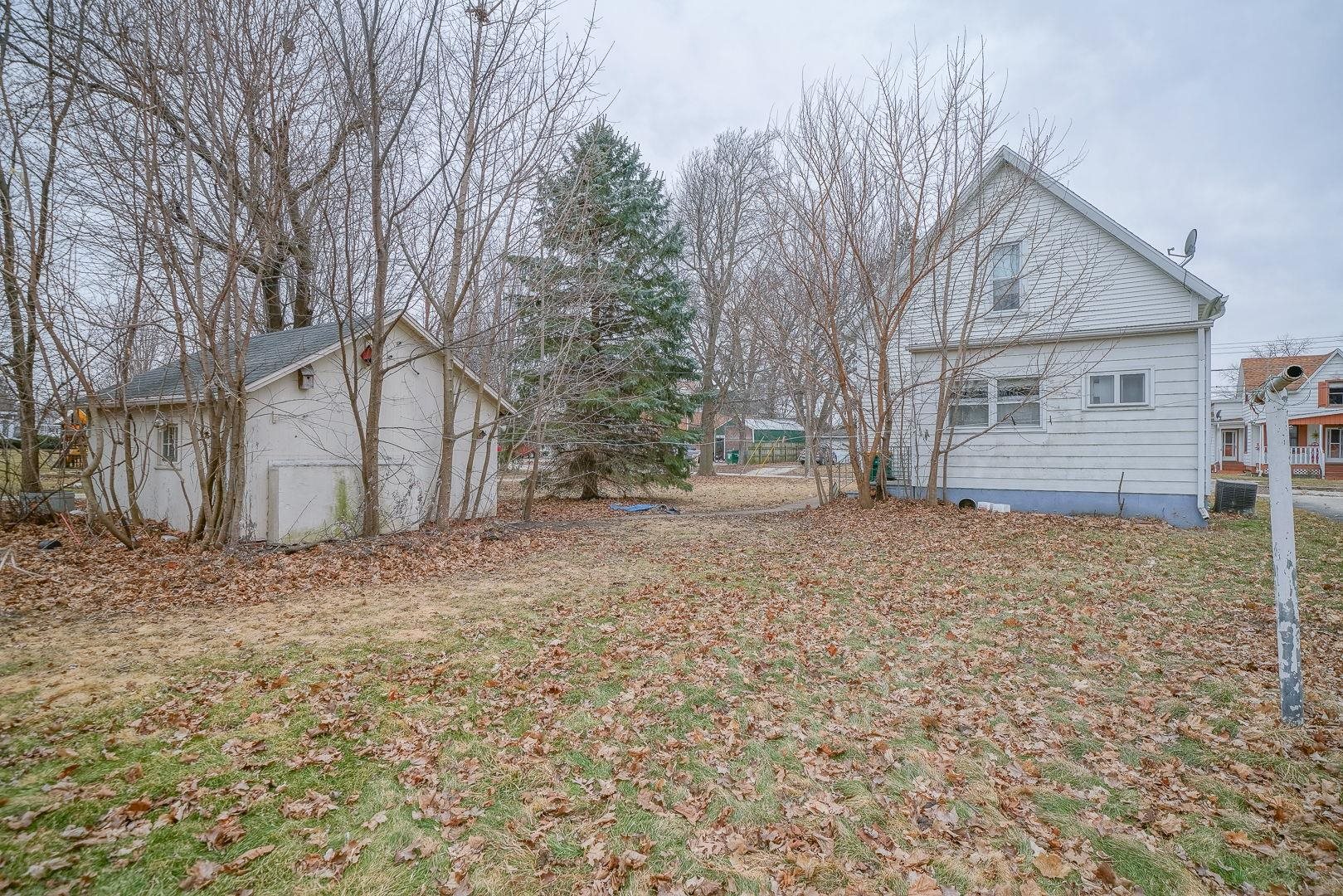 118 North Locust Street Genoa, IL 60135 - Photo 18 of 21 a view of a house with a yard