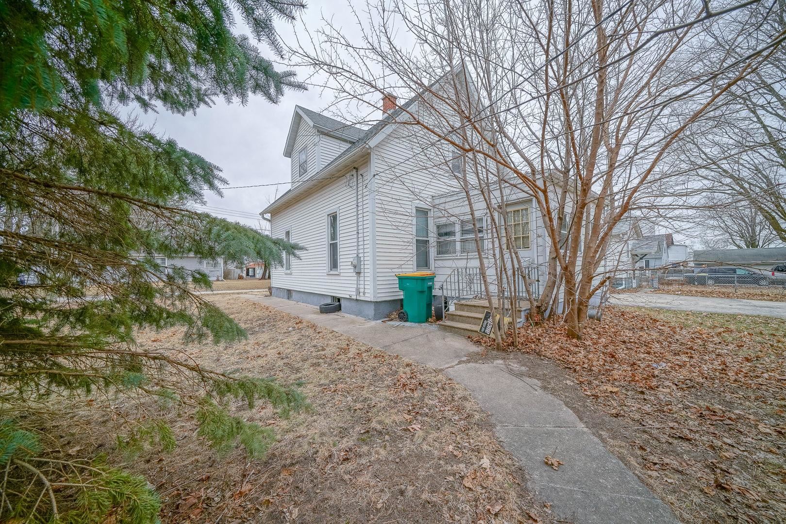 118 North Locust Street Genoa, IL 60135 - Photo 19 of 21 a view of a house with a yard and tree