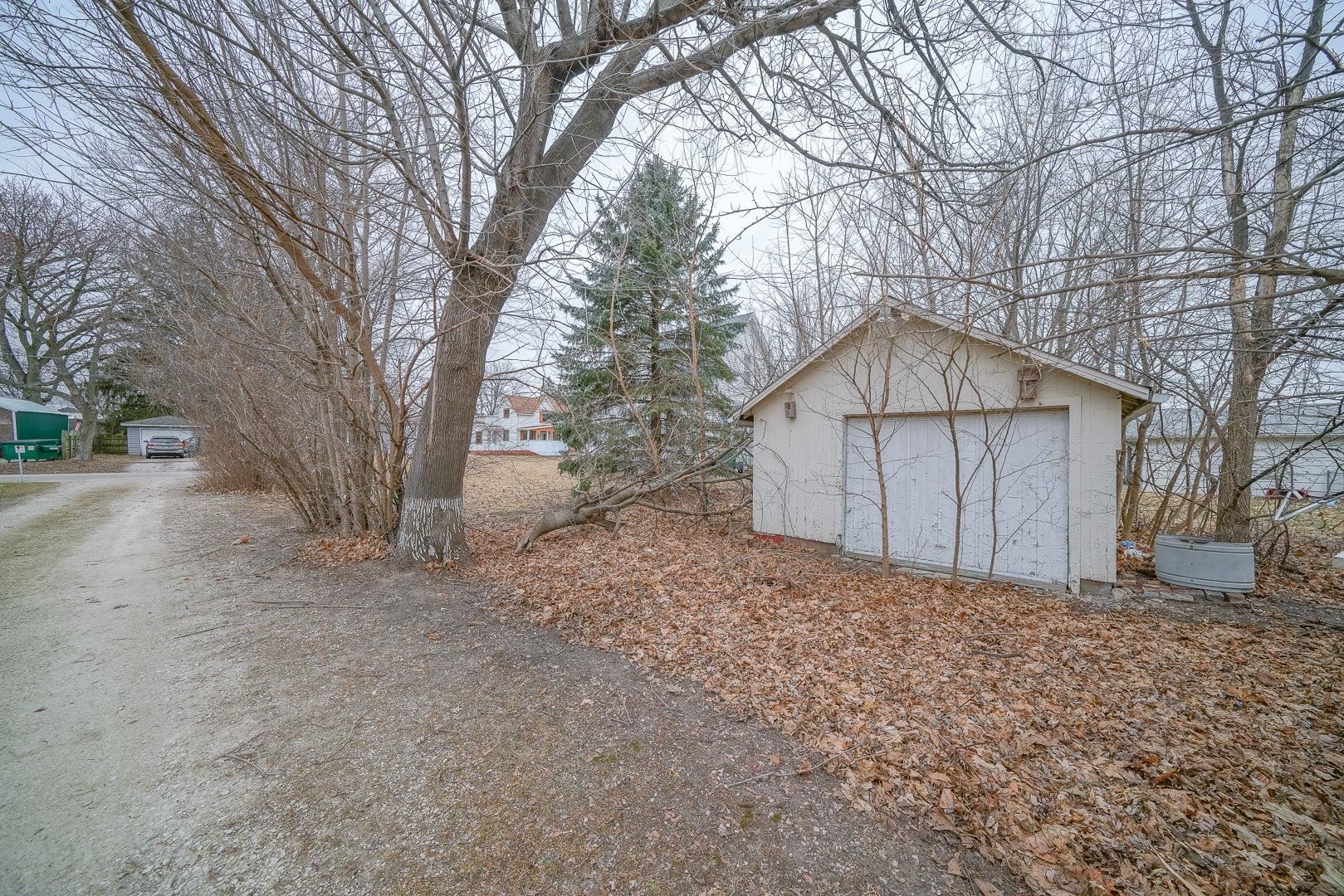 118 North Locust Street Genoa, IL 60135 - Photo 20 of 21 a house with trees in front of it