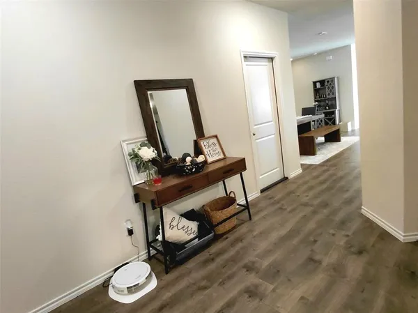 a room with wooden floor and furniture