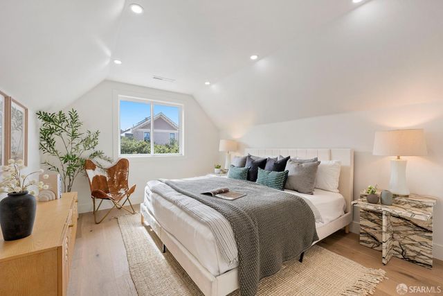 a front view of a house with lots of green space