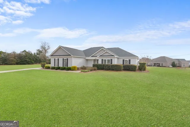 a front view of a house with garden