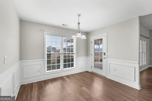 a view of wooden floor and windows in a room