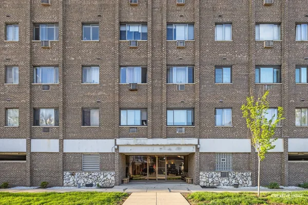 a front view of a building with garden