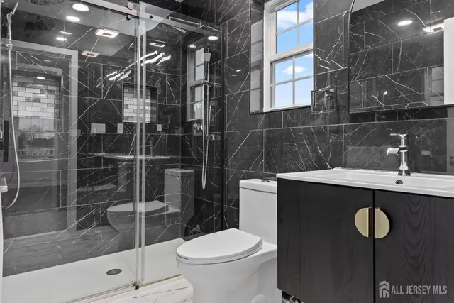 a bathroom with a sink toilet and shower