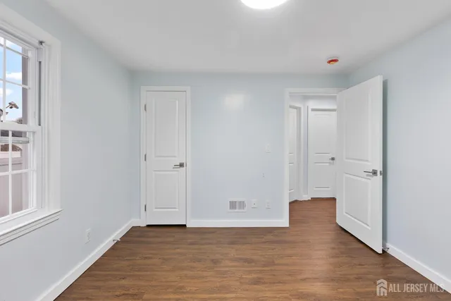a view of an empty room and wooden floor
