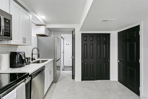 a kitchen with stainless steel appliances granite countertop a refrigerator and a sink