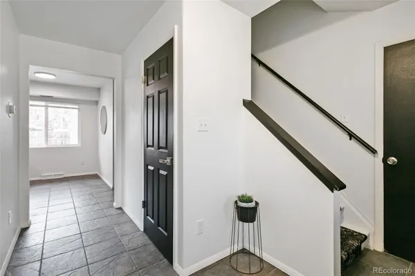 a view of an entryway with wooden floor and stairs