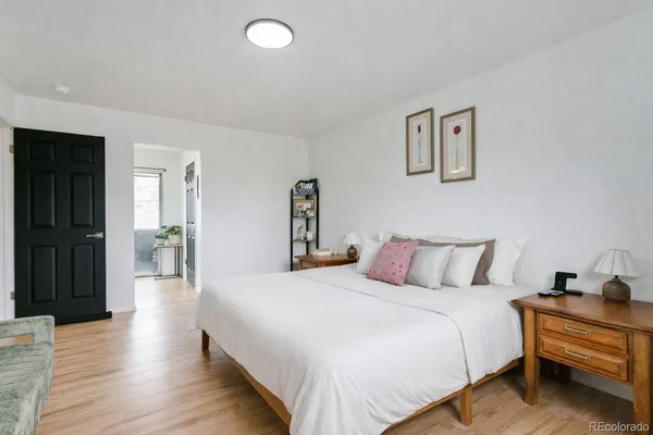 a bedroom with a bed and a lamp