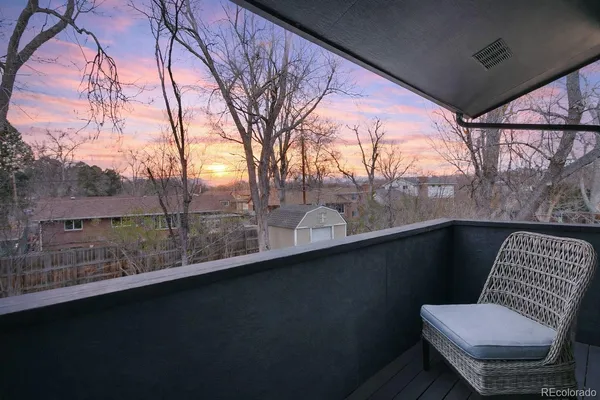 a view of a chair and table in the balcony