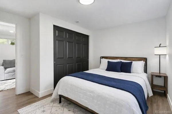 a bedroom with a bed and wooden floor